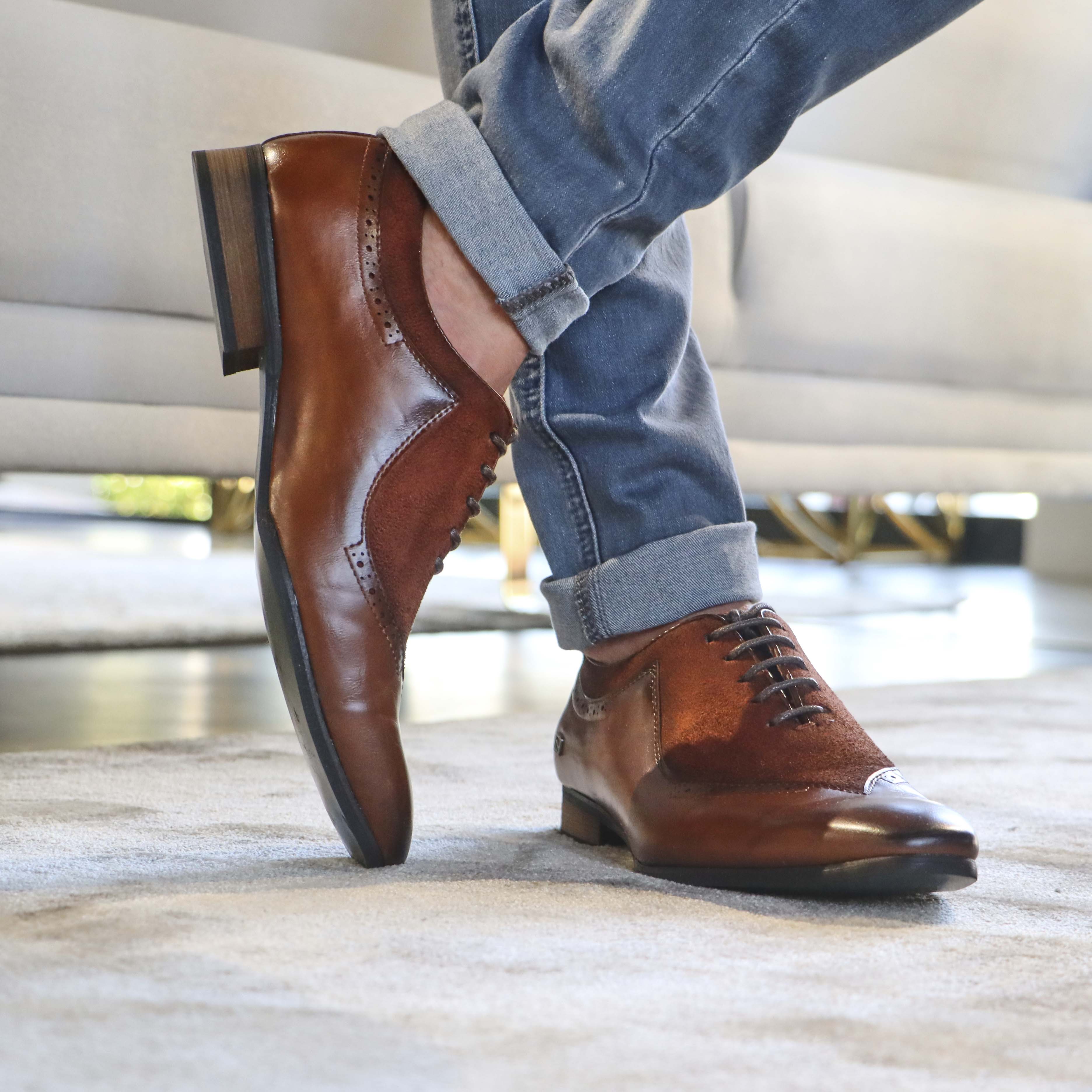 An individual dressed in refined and classic footwear.